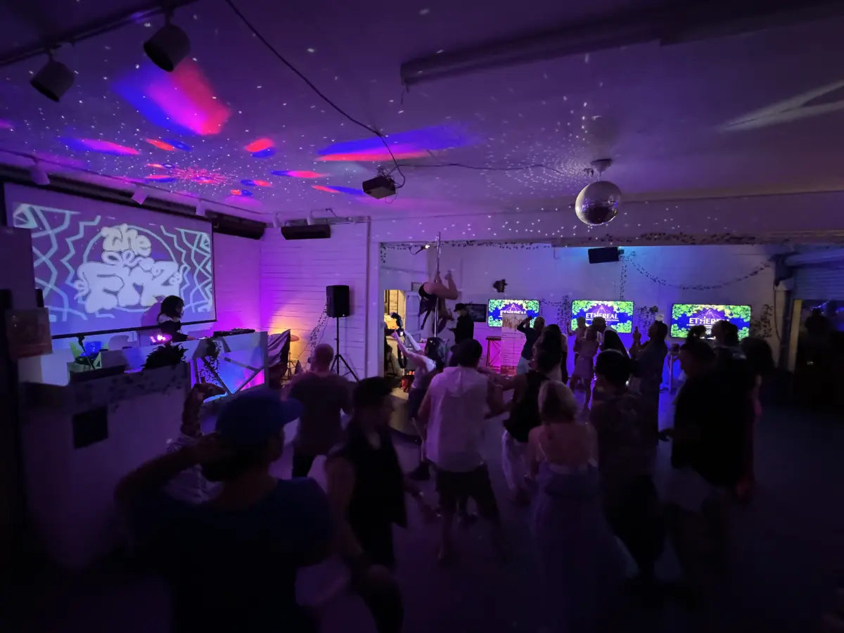 Nightclub dance party with DJ and projector at Art and Space LA venue in Los Angeles