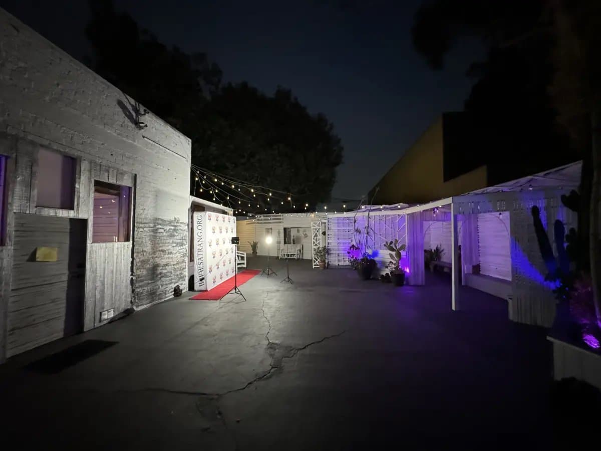 Outdoor courtyard at night with string lights and red carpet at Art and Space LA