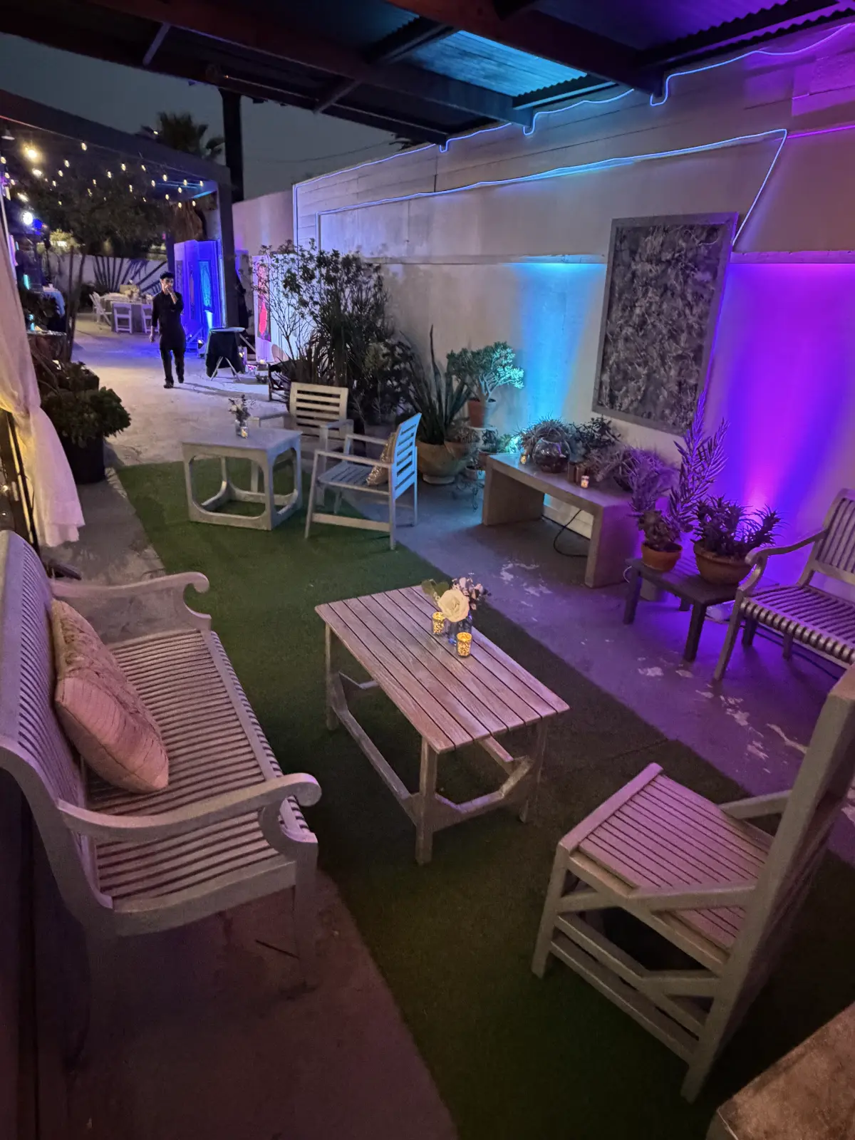 Modern outdoor lounge setup for a premium Bat Mitzvah venue in Culver City with neon lighting and wooden furniture.